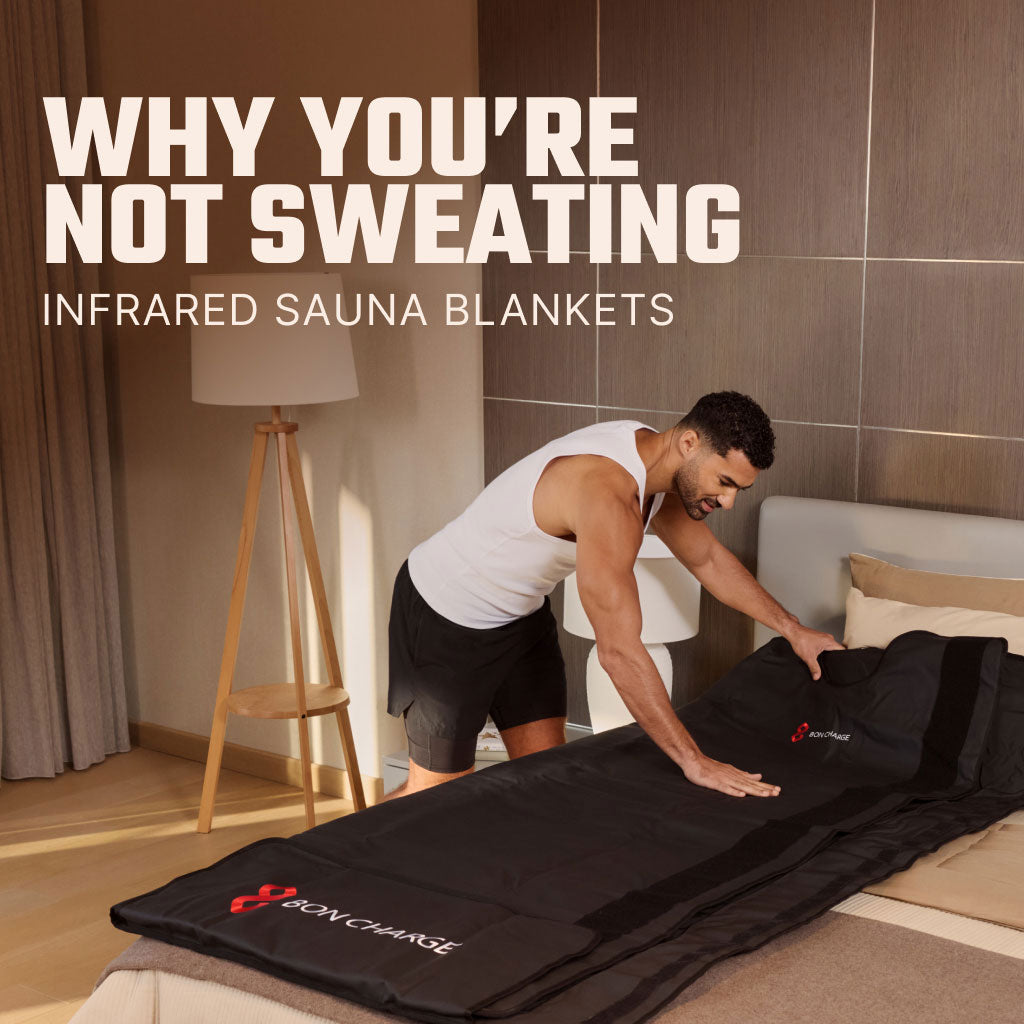Man Rolling Out Sauna Blanket On Bed